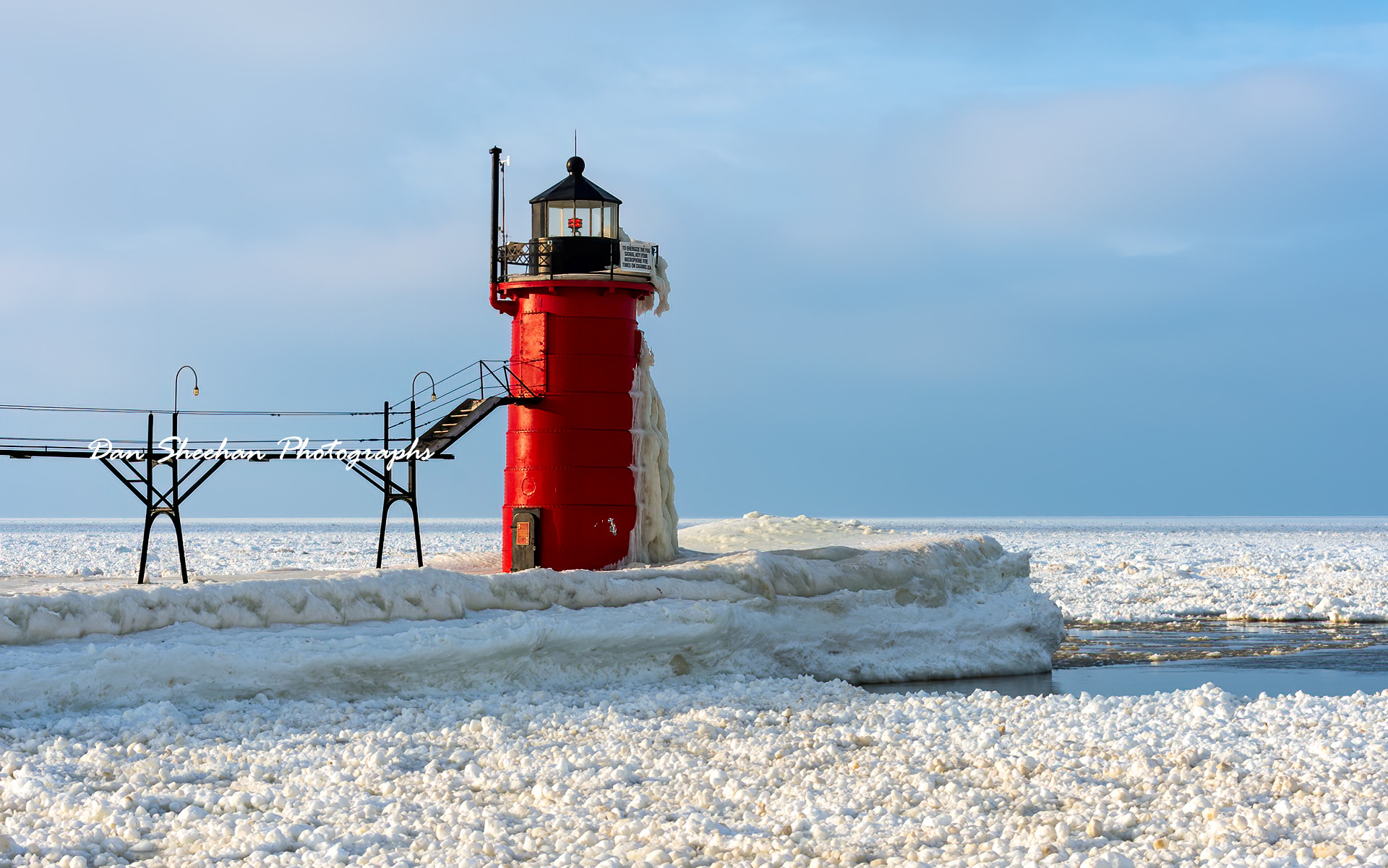 A very clean, very simple photograph that happens to be one of my favorites. The South Haven, Michigan lighthouse standing guard over a frozen Lake Michigan. : Lighthouses : Dan Sheehan Photographs - Fine Art Stock Photography